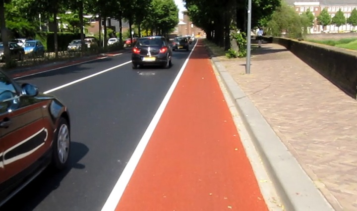 After: very smooth new asphalt with a bright red cycle lane.